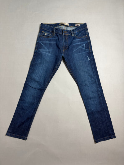 Panoramica frontale jeans denim blu scuro Guess Super Skinny su sfondo neutro