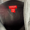 Dettaglio etichetta interna rossa GUESS con taglia XS