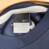 Etichetta interna Nike con taglia L e misure internazionali