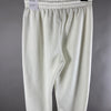 Vista posteriore dei pantaloni tuta Nike panna con cartellino fit oversized