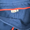 Etichetta interna Ellesse con taglia 14A sui pantaloni blu