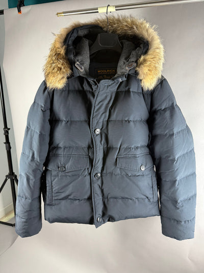 Vista frontale del piumino Woolrich blu con cappuccio e bordo in pelliccia