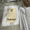 Etichetta Timberland interna con taglia 3M 60 sulla tuta da neonato